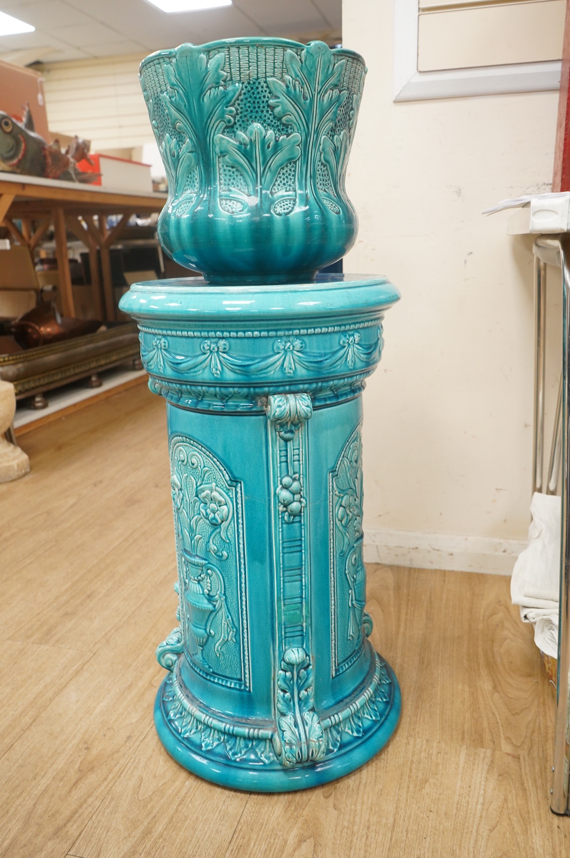A Burmantofts style turquoise glazed jardiniere and a similar larger stand, decorated in relief, 90cm high